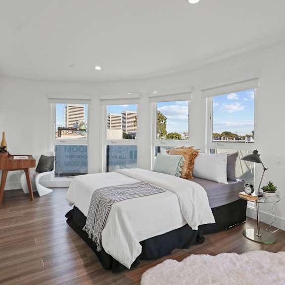 master bedroom with lots of windows and vinyl flooring