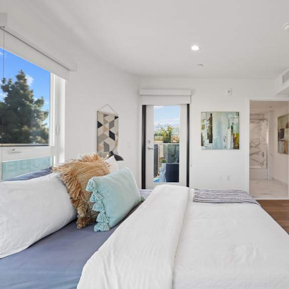 large bedroom with closet and patio access