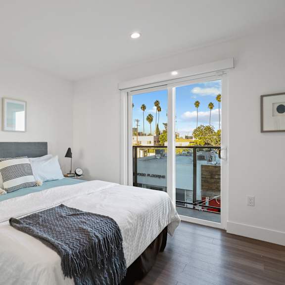 spacious bedrooms with vinyl flooring, recessed lighting, and balcony access
