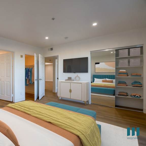 large-size bedroom with mirrored closet with shelving, vinyl flooring, and bathroom