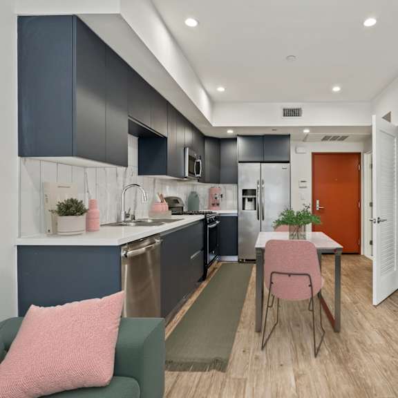 open-concept kitchen, dining, and living room with in-suite washer and dryer