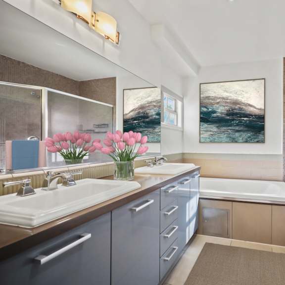 bathroom with double-sink vanity, bathtub, and walk-in shower