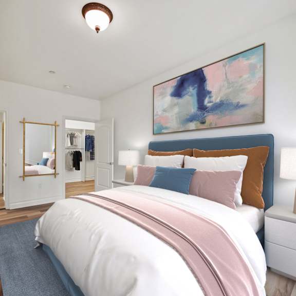 bedroom with walk-in closet with built-in organizers and bathroom