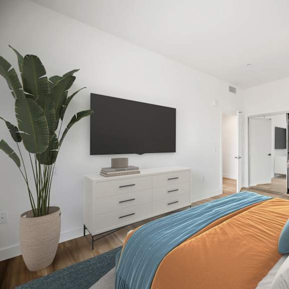 a bedroom with a large bed and a tv