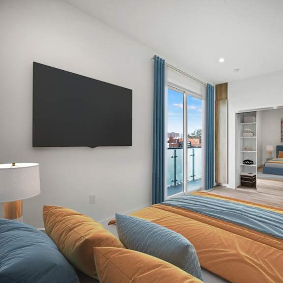 a bedroom with a large bed and a tv