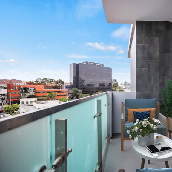 a room with a balcony and a view of the city