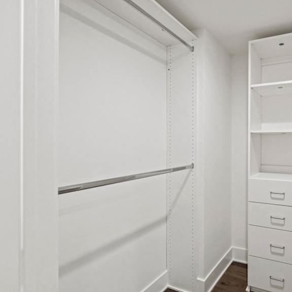 walk-in a closet with built-in organizers and shelving