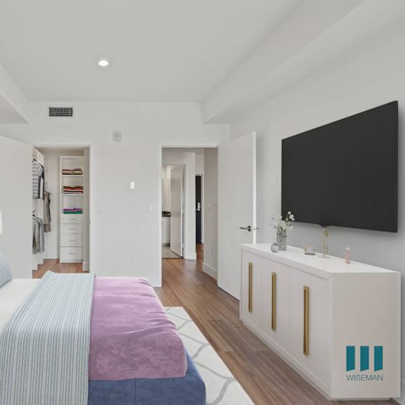 a bedroom with a bed, a nightstand, and a television.