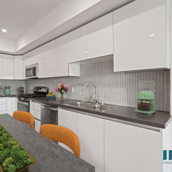 a modern kitchen with a long table and chairs.