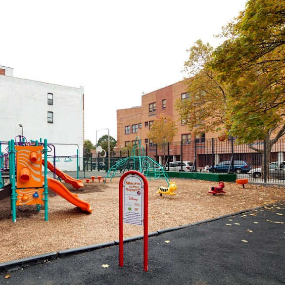 a playground in a park next to a building