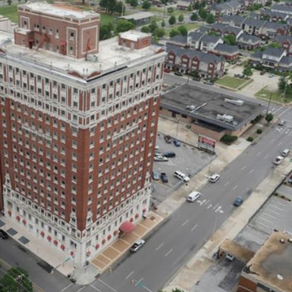 a large red brick building with a white framed window pattern.