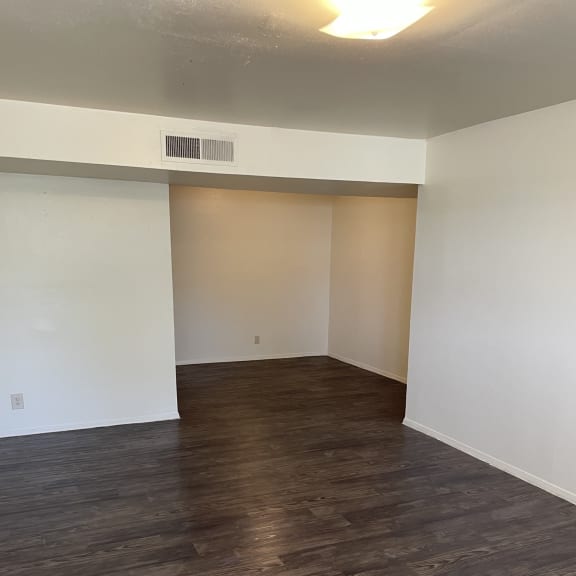 an overhead view of an empty room with wood flooring and white walls