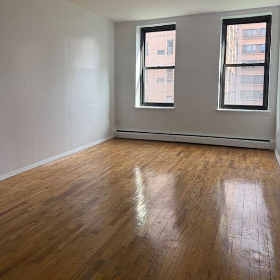 a room with a window and a wooden wall.