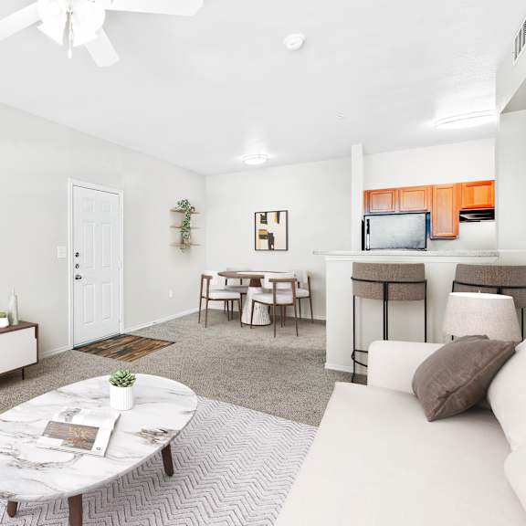 a living room with a white couch, a coffee table, and a flat screen tv.