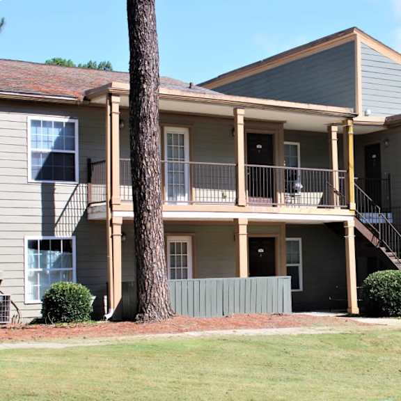 a two-story house with a balcony on the second floor at clarkston station apartments, clarkston, ga