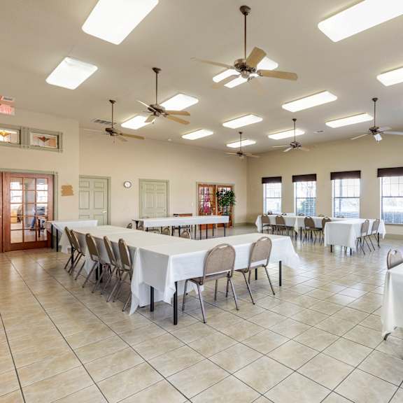 a large room with tables and chairs set up for an event.