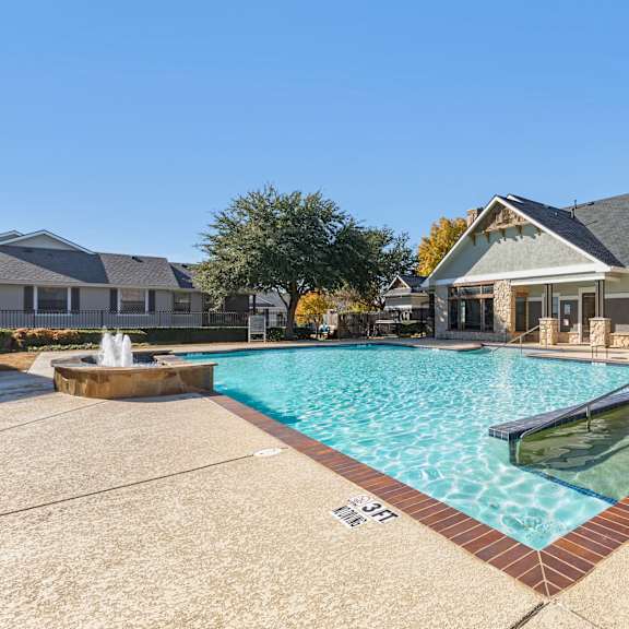 a swimming pool in front of a house.