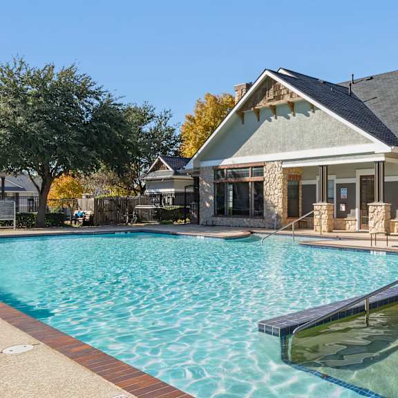 a swimming pool with a fountain in the middle of it.