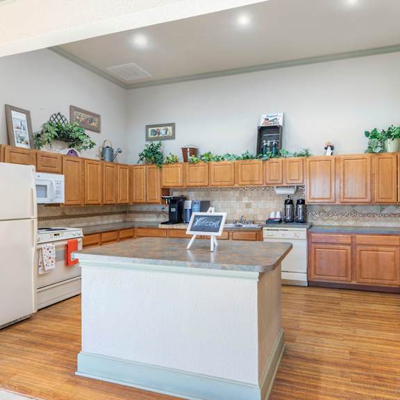 a kitchen with wooden cabinets and a white island.