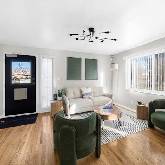 a modern living room with a flat screen tv and a white couch.