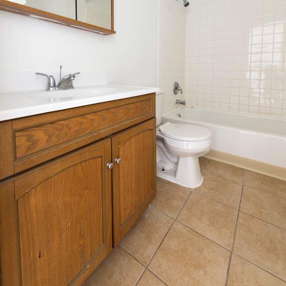 a bathroom with a toilet and a sink and a mirror