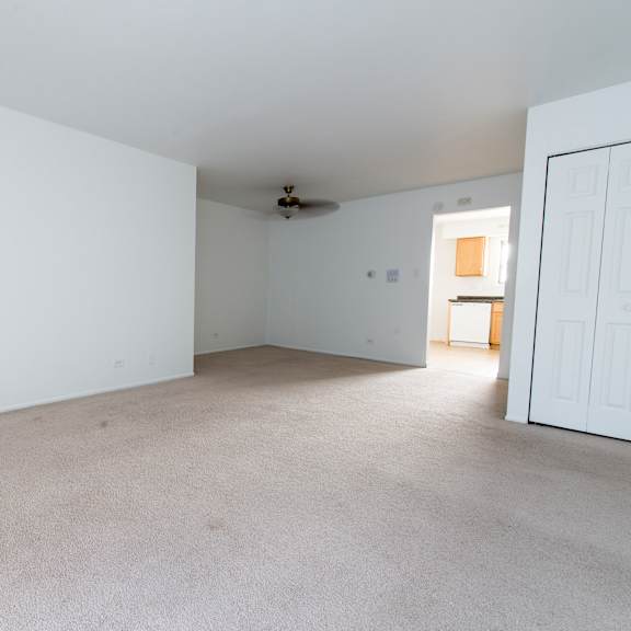 an empty living room with white walls and white doors