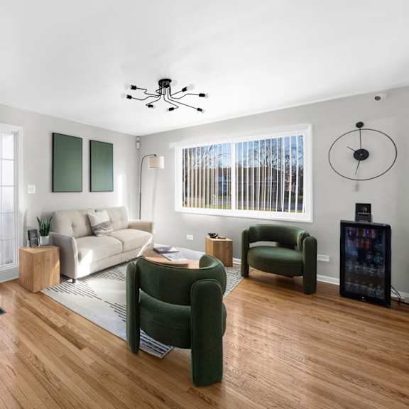 a modern living room with a green chair and a white couch.