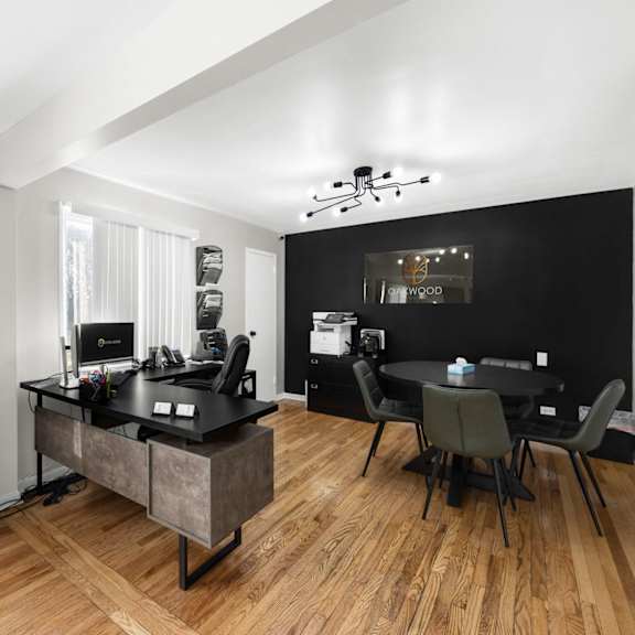 a black and white room with a desk and chairs.