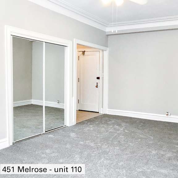 an empty room with white doors and a carpeted floor