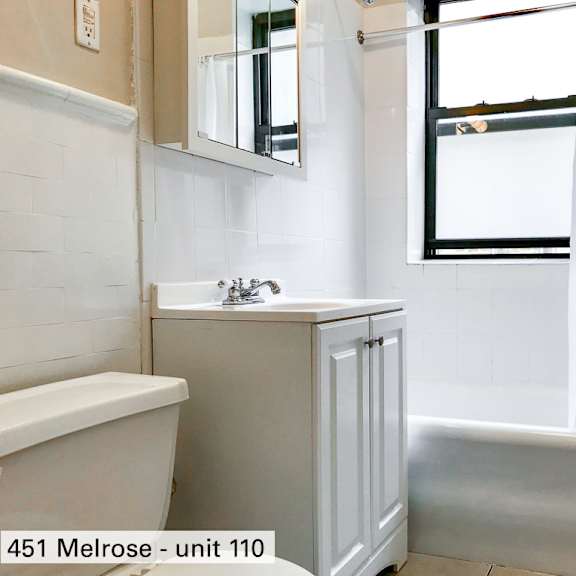 a small bathroom with a sink toilet and bath tub