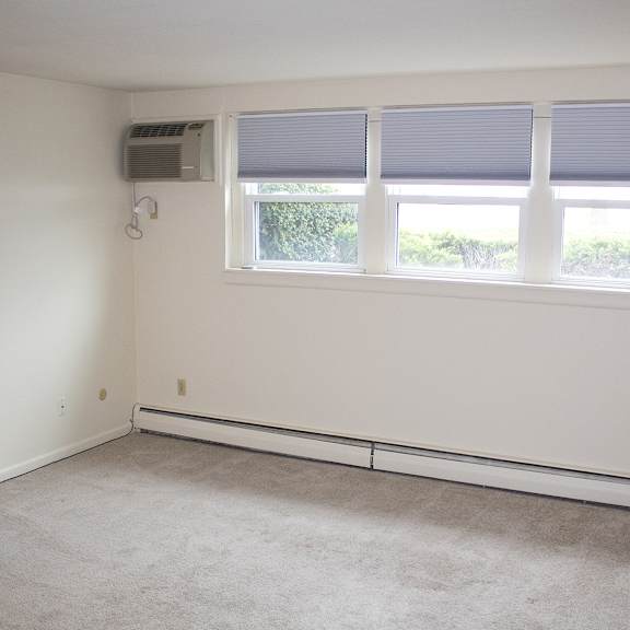 berkley manor apartments - living room – air conditioning unit – natural lighting - ask for a tour - pet friendly