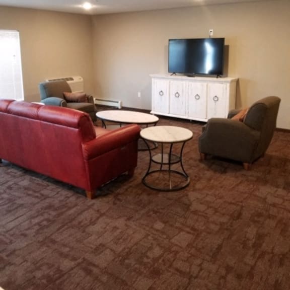community room with couches and tv area
