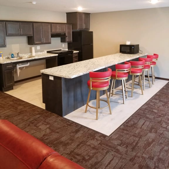 common room area with counter bar and kitchen