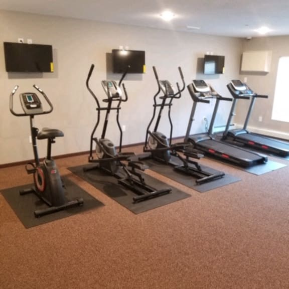 fitness room with bike, elliptical and treadmills