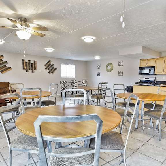 resident clubhouse community event room with kitchen, tables, and seating at integrity medina apartments, medina, oh,  44256