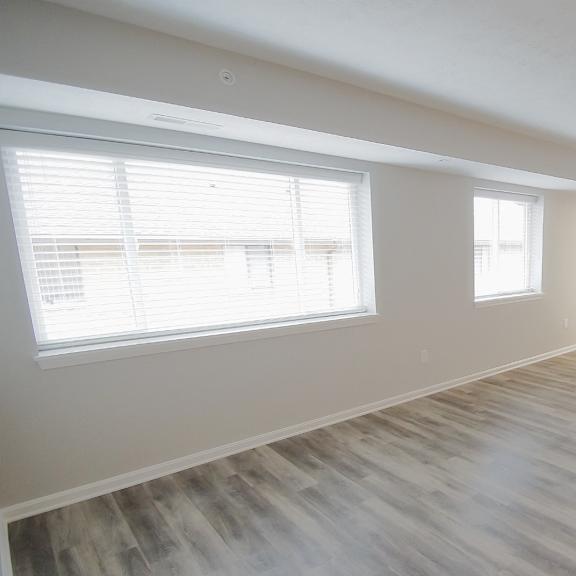 bright living room with plank-style flooring at integrity medina apartments,  ohio, 44256