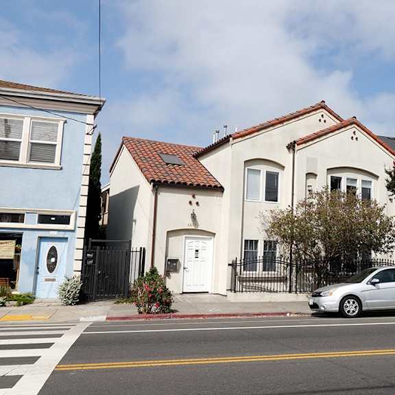 a picture of the building 6605 shattuck with a silver car in front of the building.