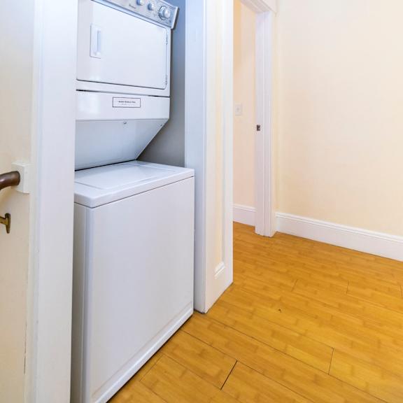 a white in unit washing machine .