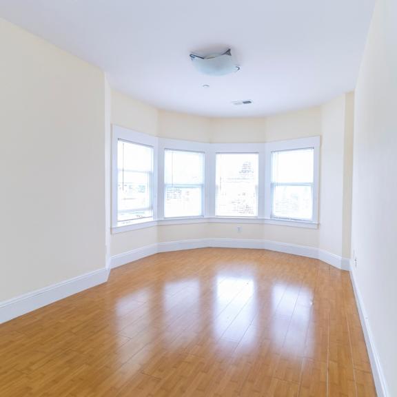 a room with wooden floors and white walls.