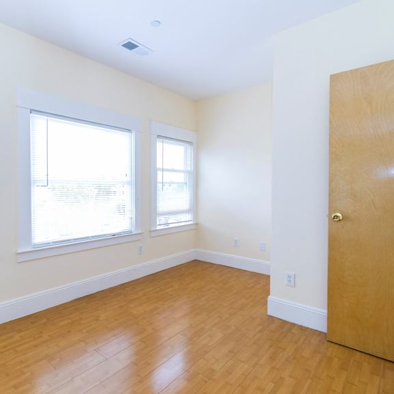 a room with a wooden floor and a wooden door.