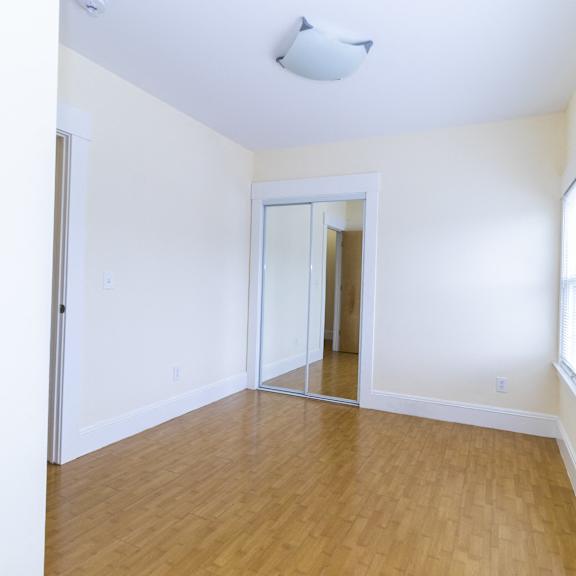 a room with a wooden floor and a sliding glass door.