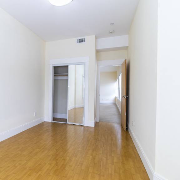 a room with wooden floors and white walls.