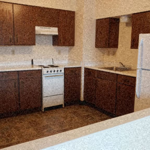 kitchen with dark cupboards and white appliances