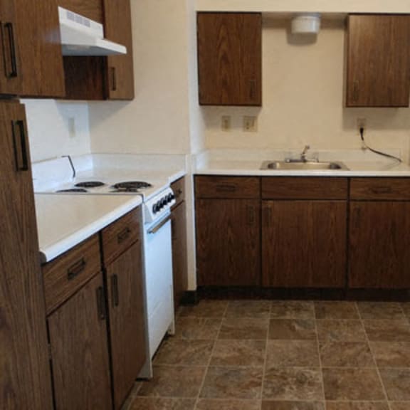 kitchen with dark brown cupboards and white appliances