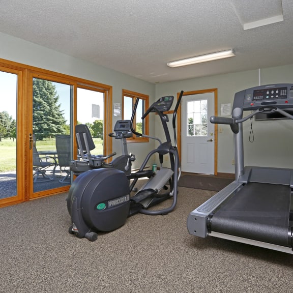 fitness room with bike and treadmill