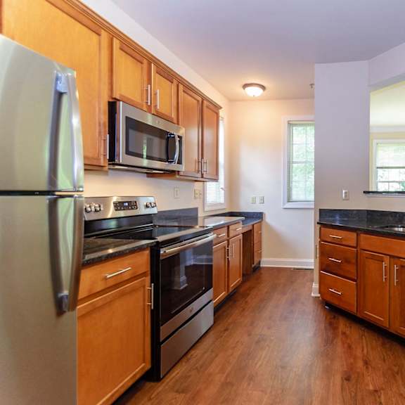 modern upgraded kitchen featuring sleek appliances and stylish finishes at claremont apartments in exton, pa