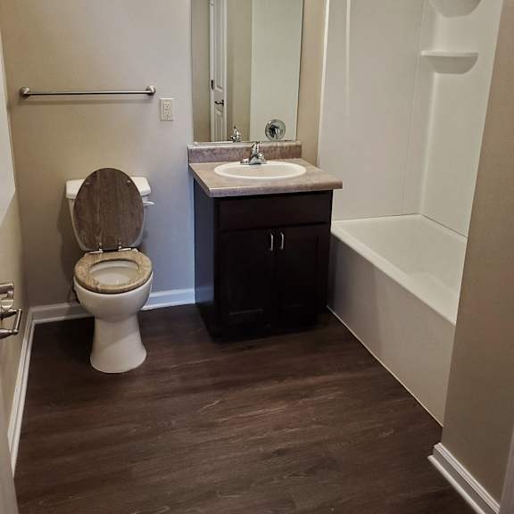 bathroom with toilet sink and shower