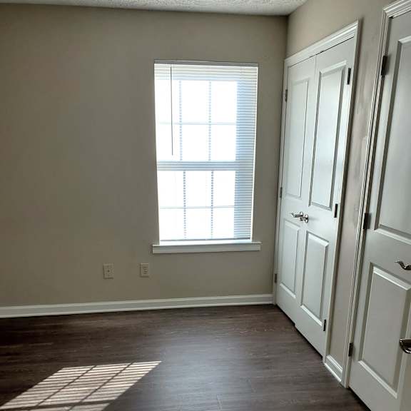 bedroom with window and closets