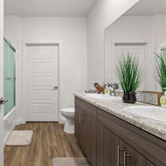a bathroom with a white door and a white toilet.
