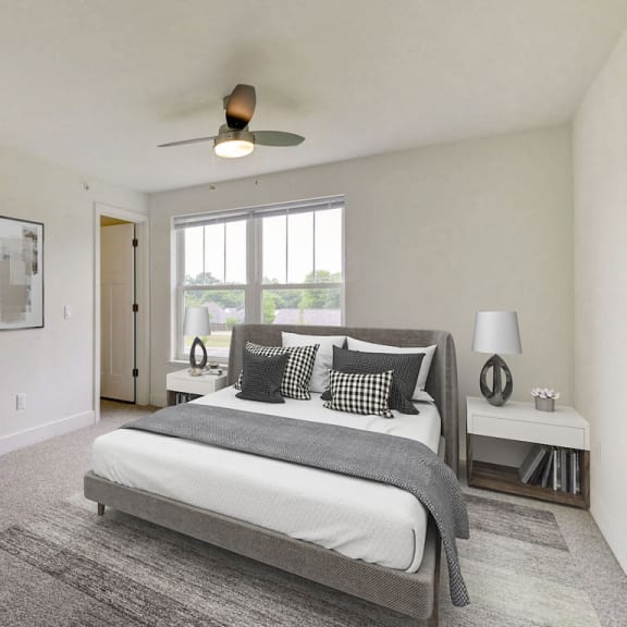 Thumbnail 11 of 17 Large bedroom with walk in closet and ceiling fan at Eagle Ridge Apartment Homes, Traverse City, Michigan